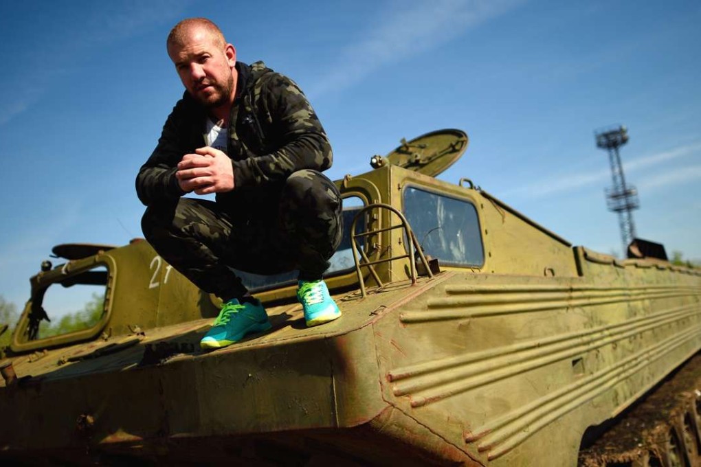 Dinko Valev poses on an old military vehicle in the town of Yambol, Bulgaria, on April 1. He has since been arrested for his “migrant hunting” activities. Photo: EPA