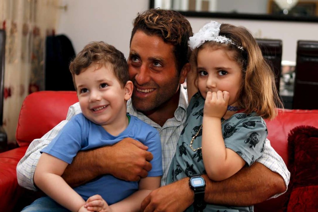 Noah (left) and Lahela al-Amin with their father Ali Zeid al-Amin in Beirut. Photo: Reuters