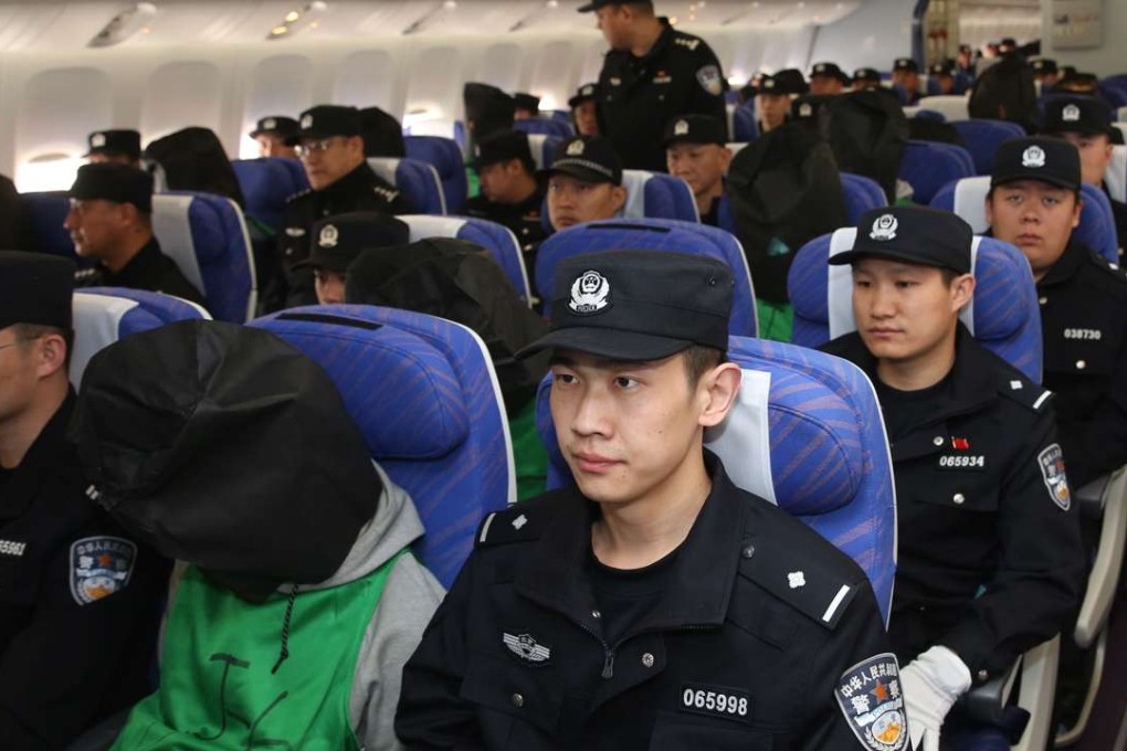 Seventy seven Chinese telecom fraud suspects - including 45 Taiwanese - arrive at the Beijing Capital International Airport in Beijing on Wednesday following their deportation from Kenya. Photo: Xinhua