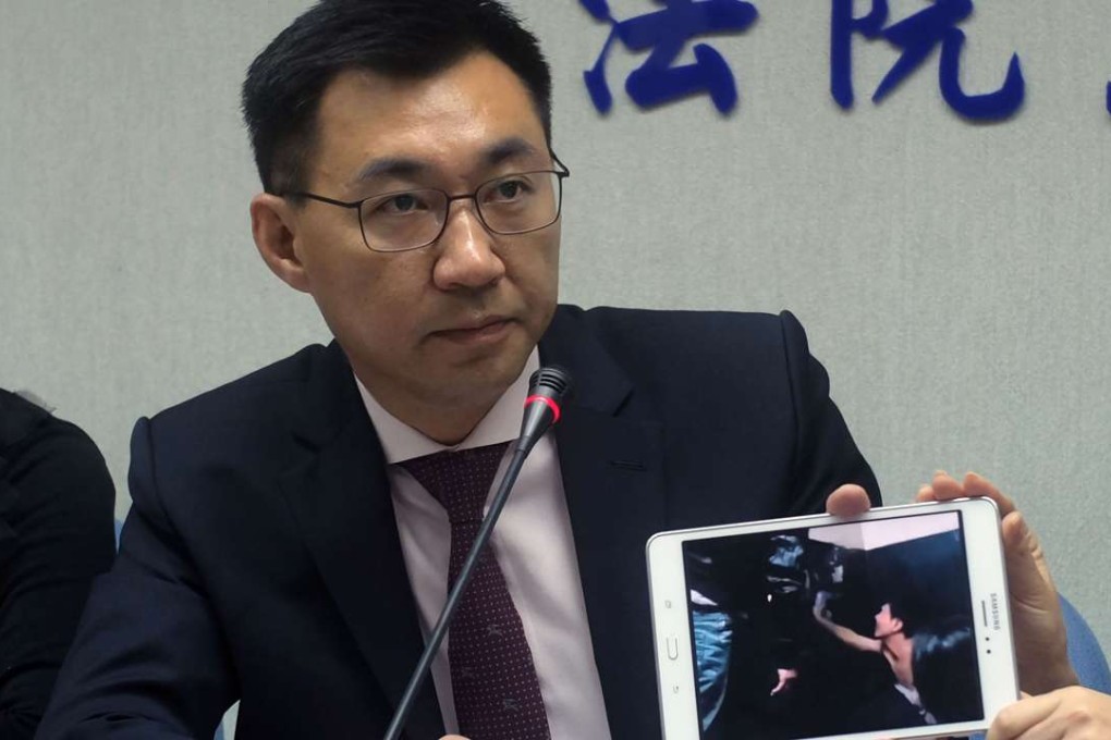 Johnny Chiang, from the Kuomintang party, displays a video clip in Taipei showing Taiwanese detained at a police station in Kenya. Photo: AFP April 12, 2016. Taiwan accused China on April 11 of kidnapping eight Taiwanese who had been cleared of criminal charges by a court in Kenya, and angrily demanded their immediate return from the mainland. / AFP PHOTO / SAM YEH