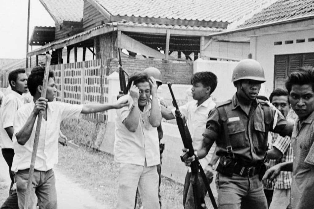 A Chinese student protects himself as he is molested by Indonesian youths who attacked the Republican University on October 15, 1965. Photo: SCMP Pictures