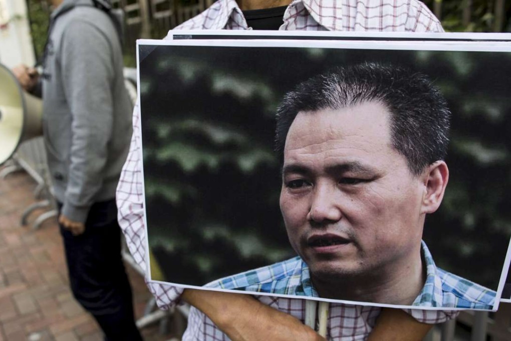 A pro-democracy protester holds a portrait of Chinese human rights lawyer Pu Zhiqiang, in Hong Kong, in December. Photo: Reuters