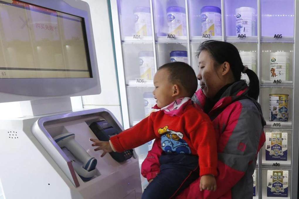 A mother buys infant formula at a vending machine that accepts credit cards and debit cards at a pharmacy in Beijing. Infant formula is one of them most popular foreign products in China. Photo: EPA