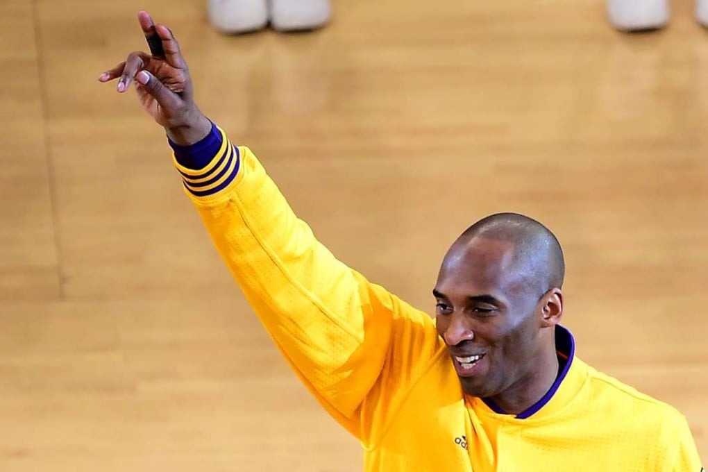 Kobe Bryant gestures to fans. Photo: AFP