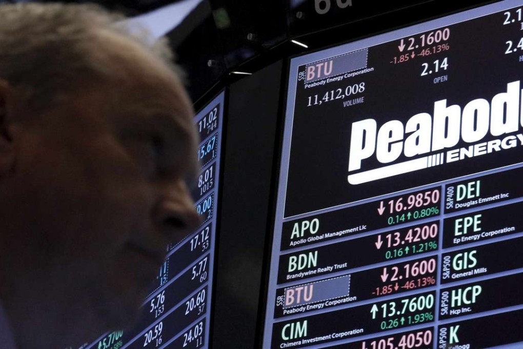 Traders work at the post where Peabody Energy is traded on the floor of the New York Stock Exchange after the world’s largest privately owned coal producer iled for US bankruptcy protection on Wednesday in the wake of a sharp fall in coal prices that left it unable to service a recent debt-fuelled expansion. Photo: Reuters
