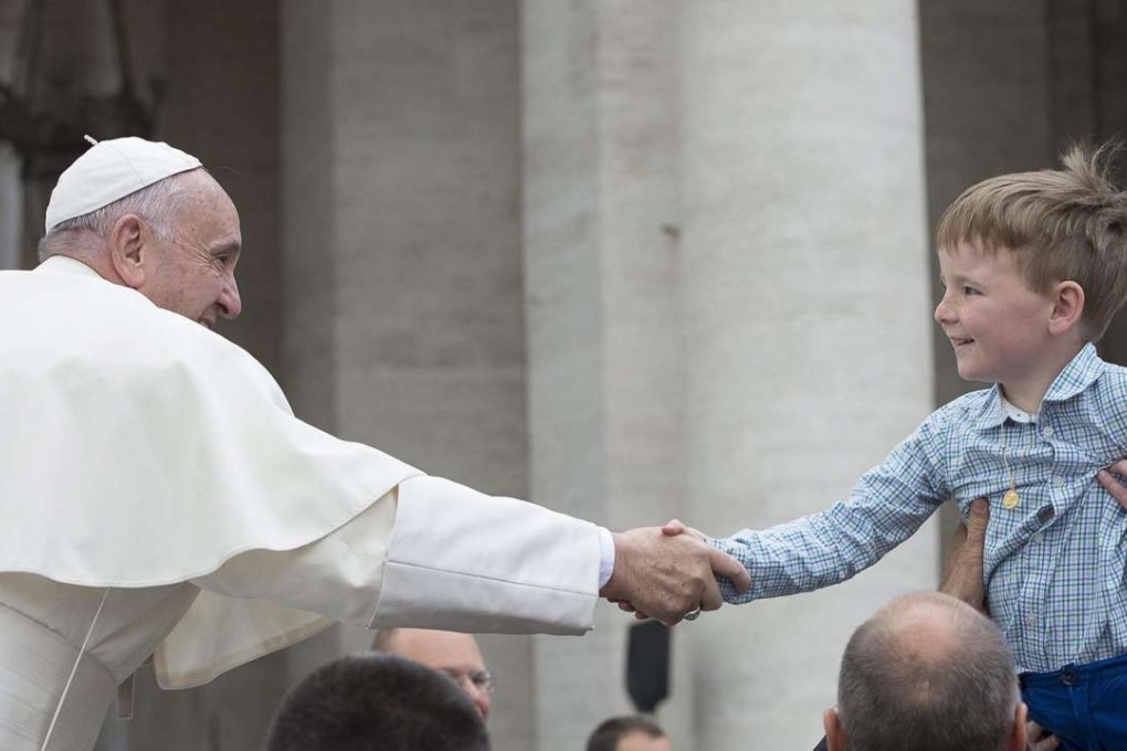 Pope Francis greets a child during his weekly general audience in St. Peter's square, Vatican City. Photo: EPA