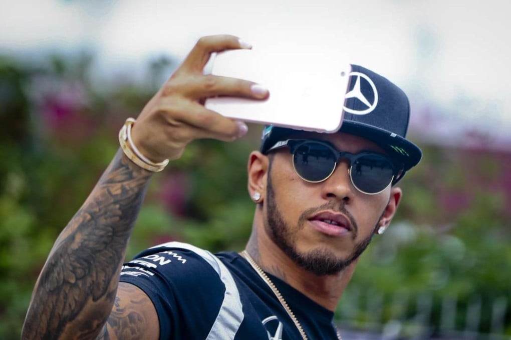 Lewis Hamilton takes a photo of himself in the paddock at the Shanghai International Circuit. Photo: EPA