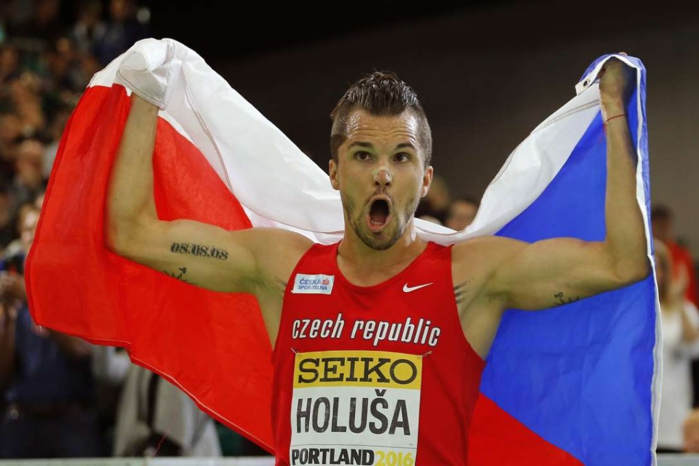 Silver medalist Jakub Holusa of the Czech republic celebrates with his country's flag after the men's 1500 meters during the IAAF World Indoor Athletics Championships in Portland, Oregon, last month. Photo: Reuters