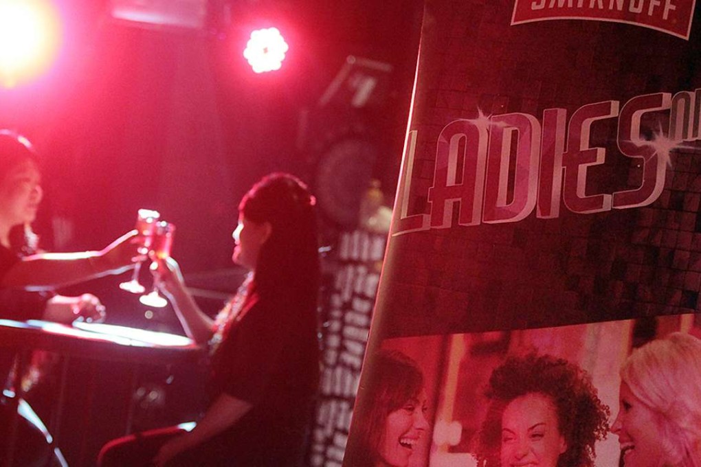 Some ladies taking a Central bar up on its offer. Photo: Bruce Yan