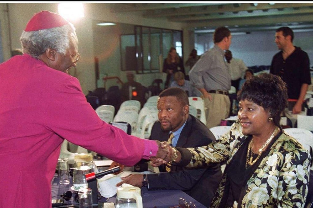 Winnie Madikizela-Mandela flanked by her legal team, shaking hands with Archbishop Desmond Tutu, chairman of the Truth and Reconciliation Commission in 1997. Photo: AFP