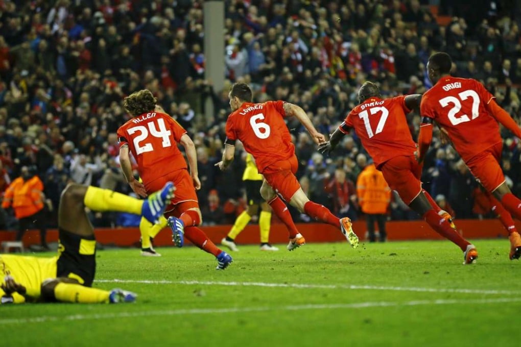 Dejan Lovren (6) celebrates his winner with his Liverpool teammates. Photo: Reuters