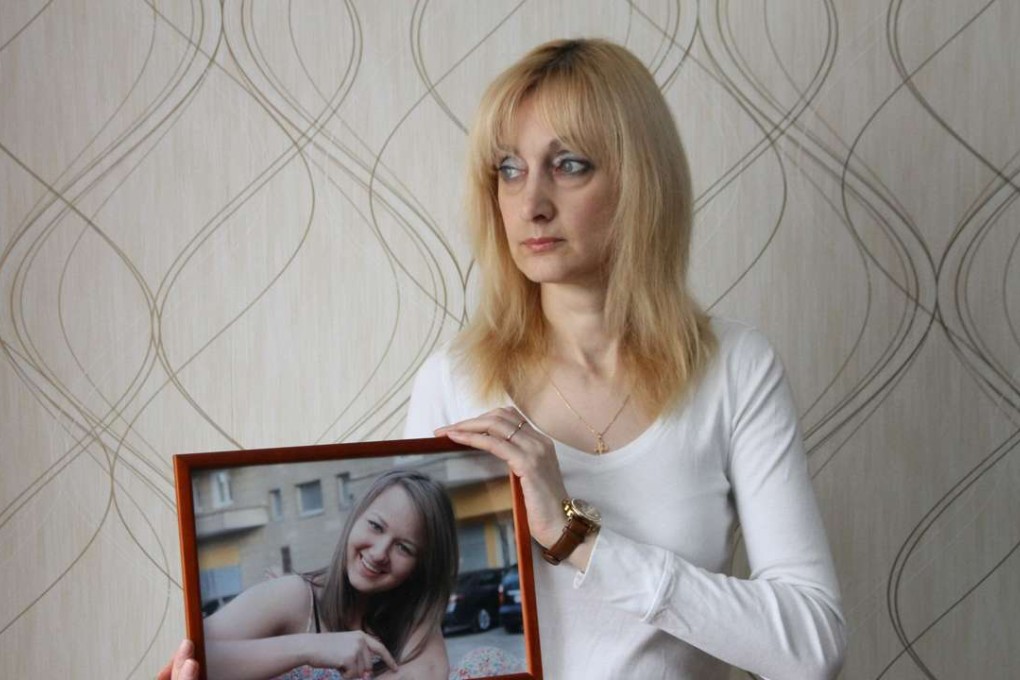 Yelena Sablina holding a photo of her late daughter Alina at her flat in Yekaterinburg. Photo: AFP