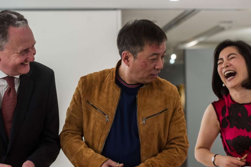 Chinese art collector Liu Yiqian (centre) cuts a ribbon to open the Christie’s spring season in Hong Kong on March 31. Photo: AFP