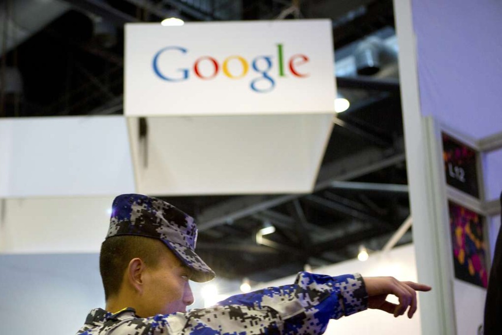 A security guard points while walking past a display booth for Google at the Global Mobile Internet Conference in Beijing. as China has run ahead of the US as a source of internet security threats due to zombie computers that are in control of hackers in the mainland. Photo: AP