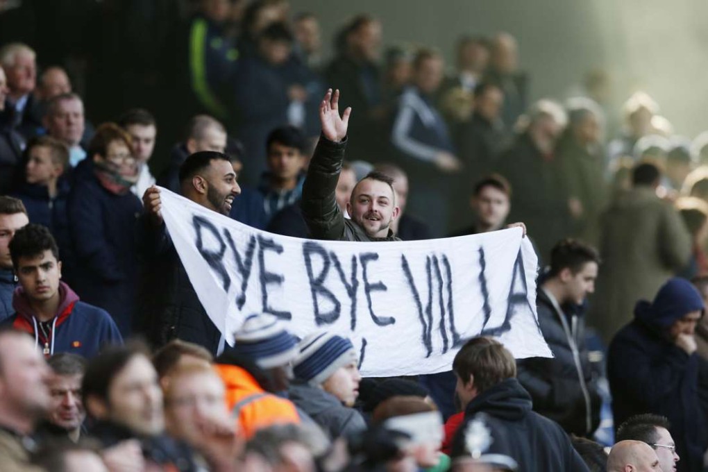 West Brom fans hold up a sign aimed at Aston Villa. Photo: Reuters