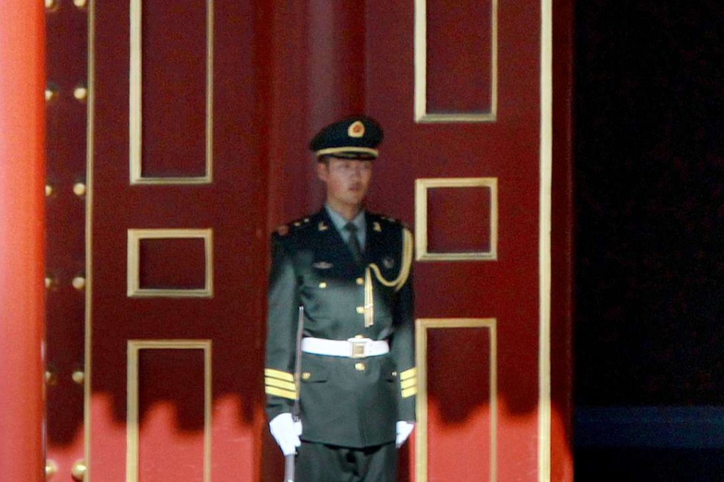 An officer guards the formal entrance to the Zhongnanhai compound, in Beijing. If the central authority is weak government decrees can fail to reach beyond the walls of Zhongnanhai. Photo: Simon Song