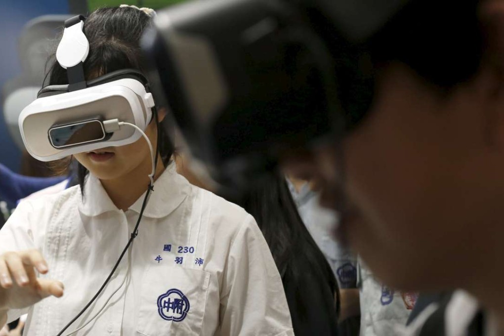 Visitors try 3Glasses D2 Vanguard by China's Virtual Reality Technology during the Spring Computer show in Taipei. Photo: Reuters