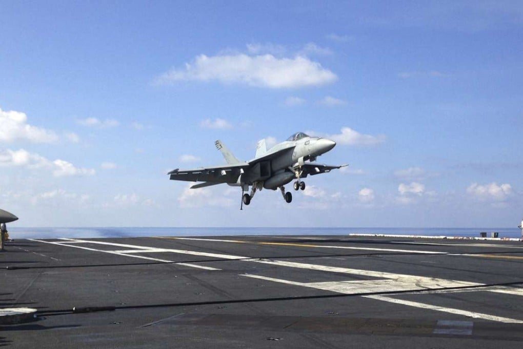 An FA-18 jet fighter lands on the USS John C. Stennis aircraft carrier in the South China Sea. Photo: AP