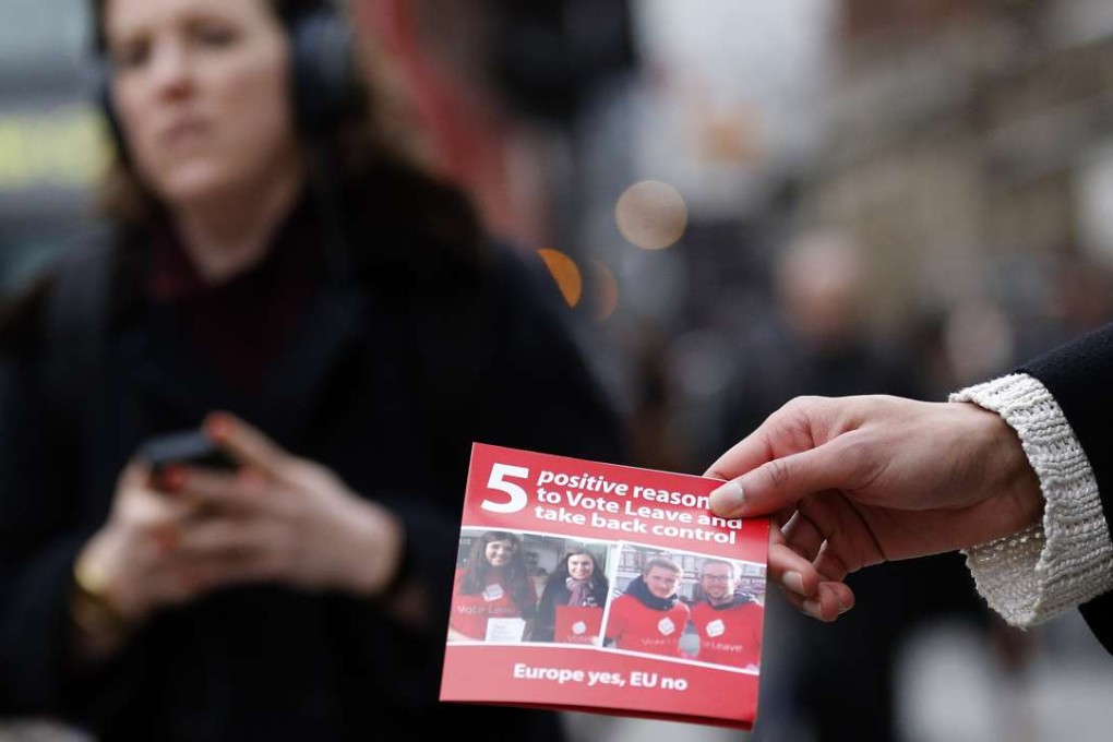 A pro-Brexit campaigner hands out leaflets at Liverpool Street station in London. Photo: AP