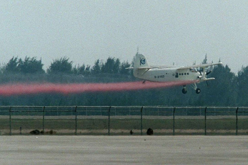 A Chinese-made light aircraft spray coloured smoke during a demonstration flight at Zhuhai Air Show. Photo: David Wong