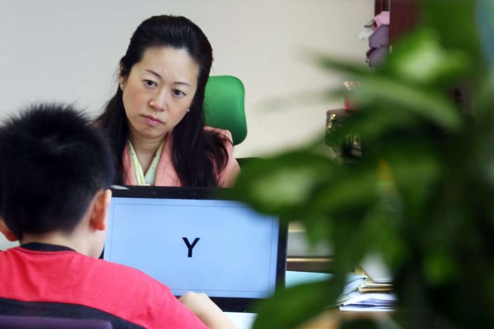 Dr Fanny Lam Wai-fan, specialist in developmental-behavioural paediatrics, Hong Kong Developmental Paediatrics Centre, conducts an attention test for a nine-year-old autistic boy. Photo: Nora Tam