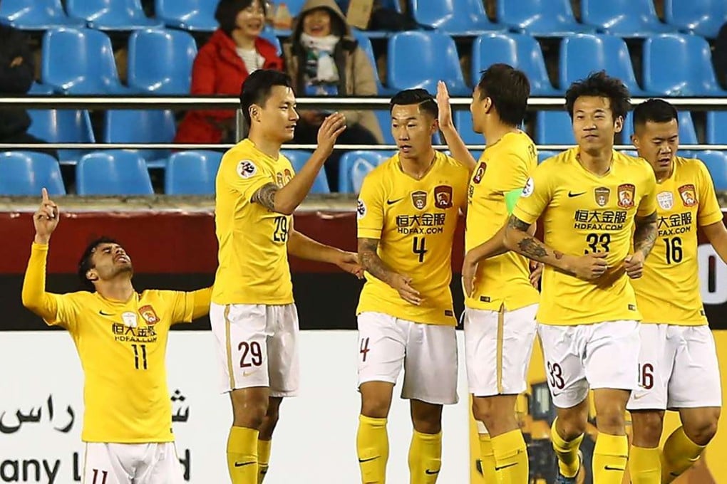 Ricardo Goulart kneels on the ground while his Guangzhou Evergrande celebrate his goal during the group H encounter. Photos: AFP