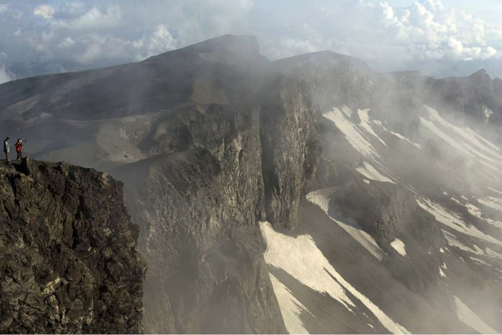 A North Korean television camera crew filming at the peak of Mount Paektu in 2014. Photo: AP