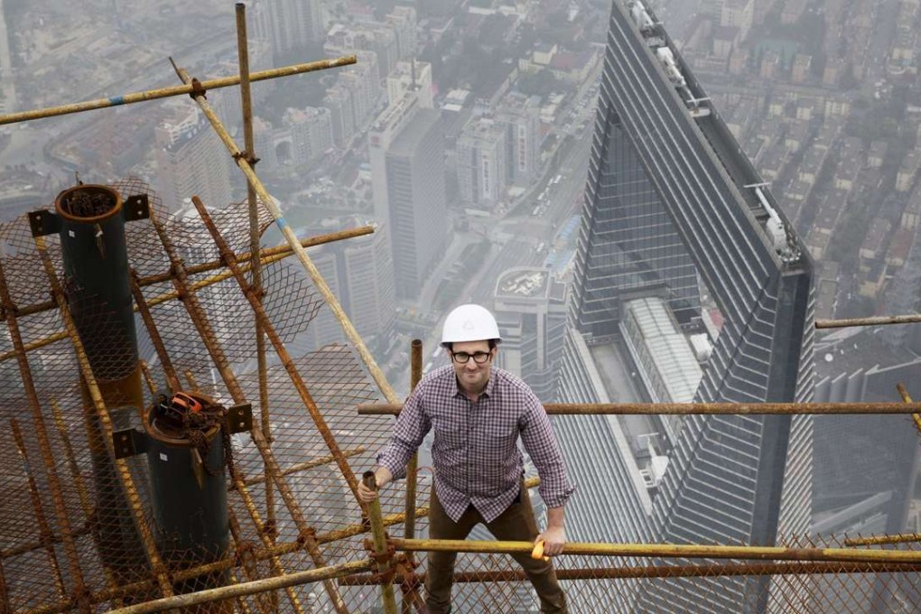 Record household credit growth in March has helped to reignite housing markets across China, with the epicentre of price acceleration in top cites such as Shanghai (pictured) and Shenzhen. This image shows Danny Forster, architect and host of Discovery Channels’ “How China Works” standing on building scaffolding high above Shanghai. Photo: AFP/Discovery Networks