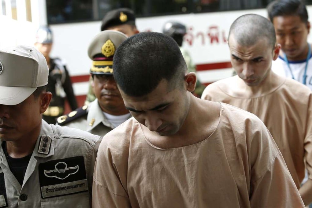 Alleged Erawan Shrine bombing suspects Yusufu Mieraili (centre) and Adem Karadag (back) are escorted by police officers and prison personnel as they arrive at the Military Court in Bangkok, Thailand on 20 April 2016. Photo: EPA
