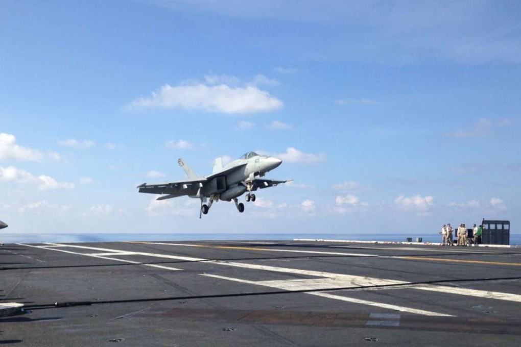 An FA-18 jet fighter takes off on the USS John C. Stennis, an American aircraft carrier in the South China Sea on Friday, April 15, 2016. US ships have started conducting joint patrols in the South China Sea with the Philippines. Photo: AP