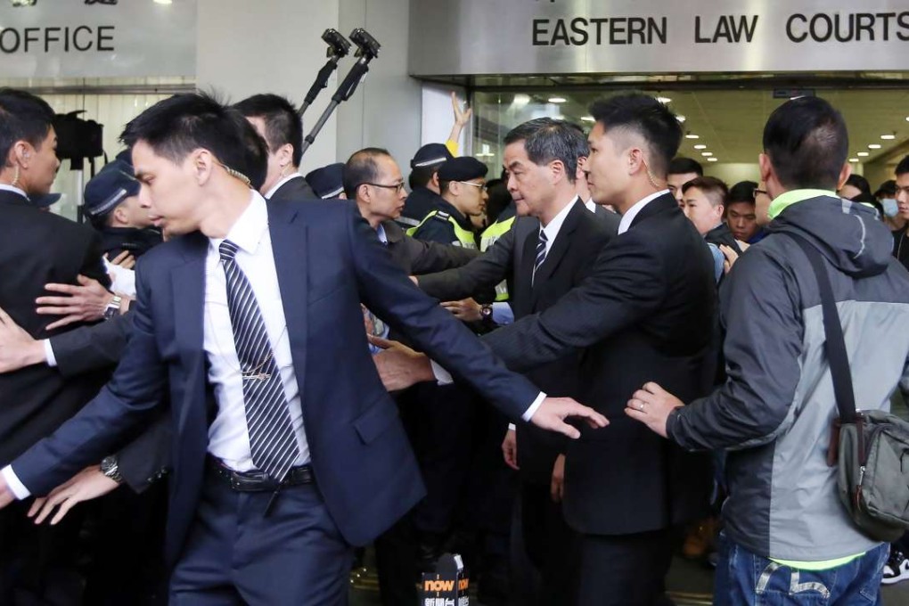 There are chaotic scenes as Chief Executive Leung Chun-ying leaves Eastern Court. Photo: Sam Tsang