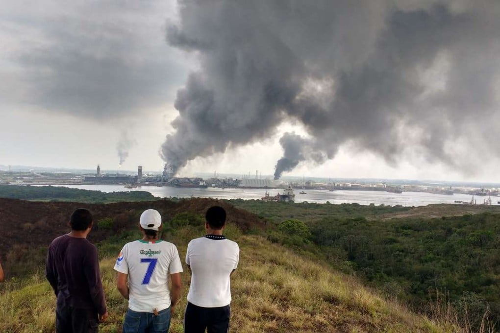 Residents watch smoke billow from a petrochemical plant in Coatzacoalcos, Mexico on Thursday. Photo: AFP