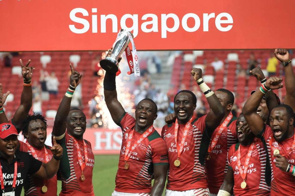 Kenya's team celebrate with the trophy after defeating Fiji in the cup final at the Singapore Sevens. Photo: AFP