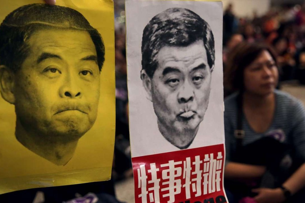 Protesters hold up pictures of Chief Executive Leung Chun-ying during a protest at Hong Kong International Airport last Sunday. Photo: AFP