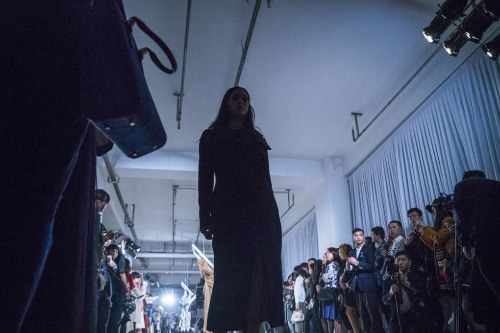 Models show creations from Haizhen Wang’s collection during Shanghai Fashion Week .