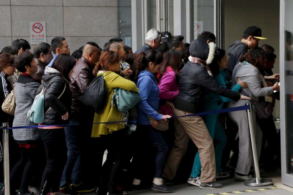 People rush into Peking Union Hospital in Beijing early this month. Photo: Reuters