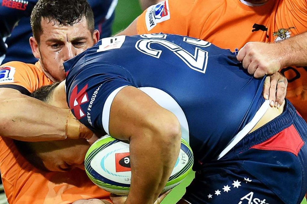 Shaun Venter of the Cheetahs tackles Sione Tuipulotu of the Rebels during their Super Rugby match at AAMI Park in Melbourne on Friday night. Photo: EPA