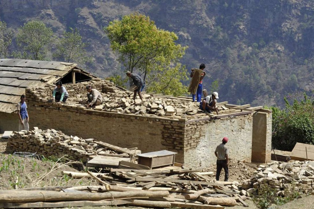 Nepalese workers rebuild in Ramechhap, an area damaged by the earthquake last year. Photo: AFP