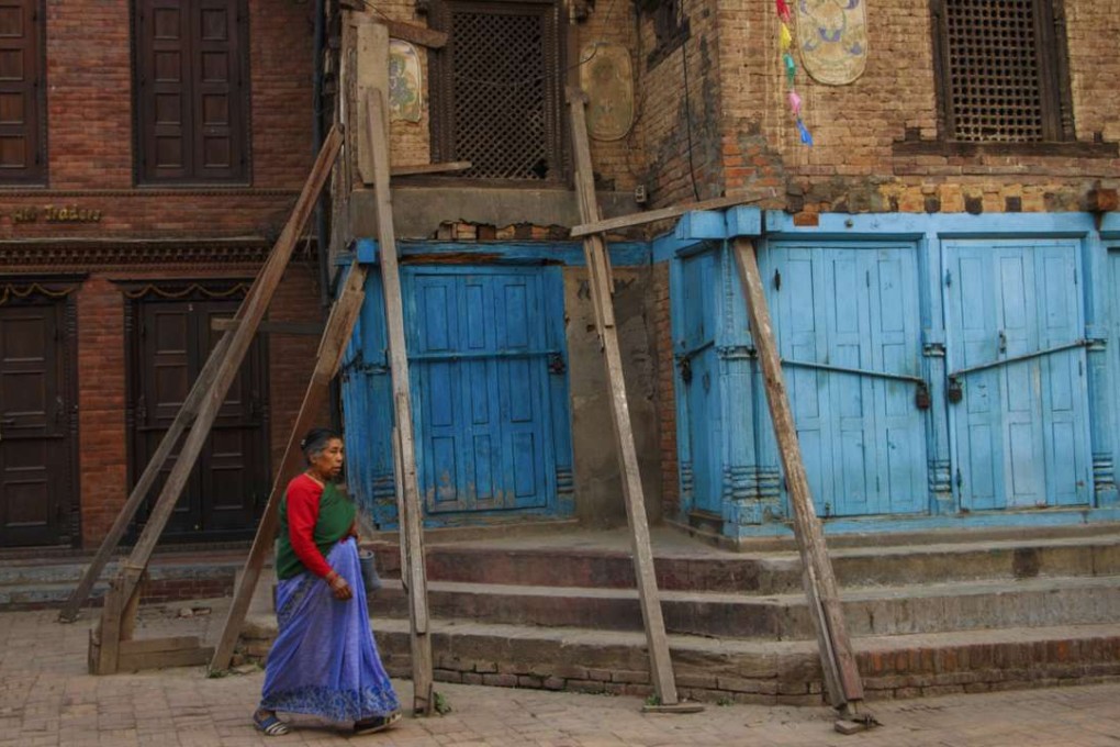 A woman wearing traditional dress walking through the back streets behind Patan Durbar Square. Photo: Tessa Chan