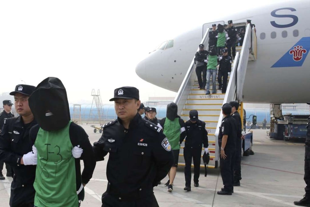 A file picture of the suspects extradited from Kenya as they are led off a plane in Beijing. Photo: Xinhua
