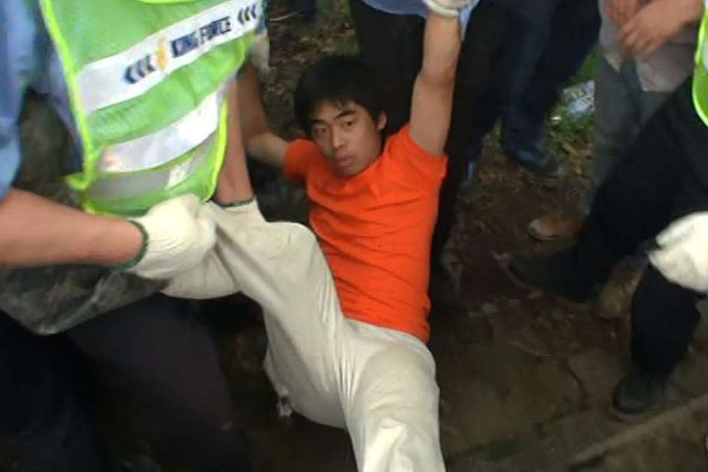A man is carried away from the Mapopo Community Farm in Fanling during the clearance operation. Photo: SCMP Pictures