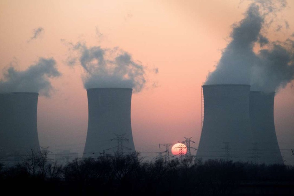 Smoke rises from a power plant near Hengshui in China's northern Hebei province as the sun sets in the background. Photo: AFP