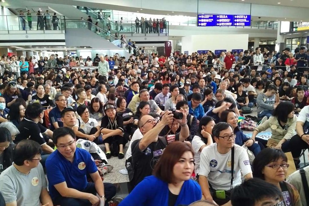 As many as 2,000 protesters at Hong Kong's Chek Lap Kok International Airport on April 17. They were calling for clarity on airport security measures, after Chief Executive Leung Chun-ying became embroiled in a scandal over claims he pressured airline staff to carry luggage through the airport to his daughter. Photo: Kyodo