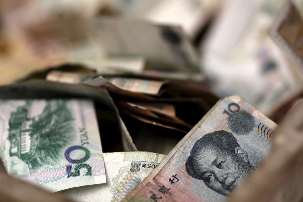 Chinese banknotes are seen in a vendor's cash box at a market in Beijing. China’s renminbi is closer to joining the major league of reserve currencies with a deal to include it in the International Monetary Fund's unit of account. Photo: Reuters