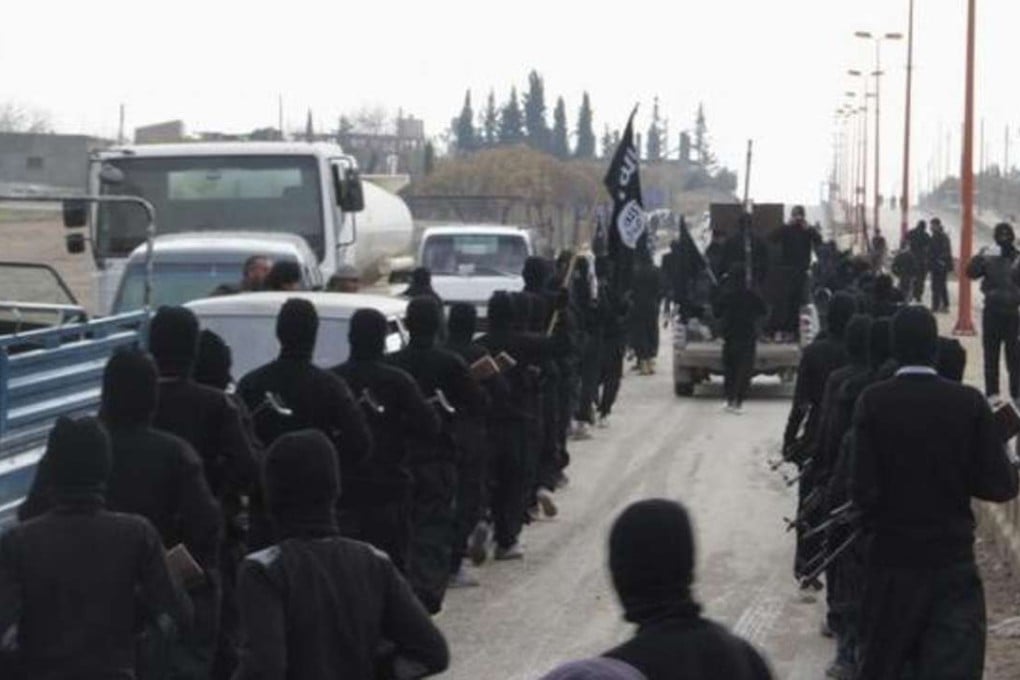 A file picture of Islamic State fighters marching through a town in Syria. Photo: Reuters