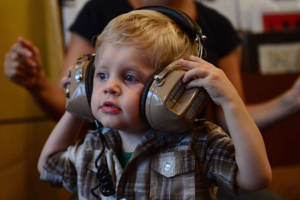 A toddler taking part in a "Baby DJ School" class, aimed at preschool children to learn the basics on how to mix music, in New York. Babies who engage in musical play may have an easier time picking up language skills, suggested a study. US researchers compared nine-month-old babies who played with toys and trucks to those who practiced banging out a rhythm during a series of play sessions. Photo: AFP