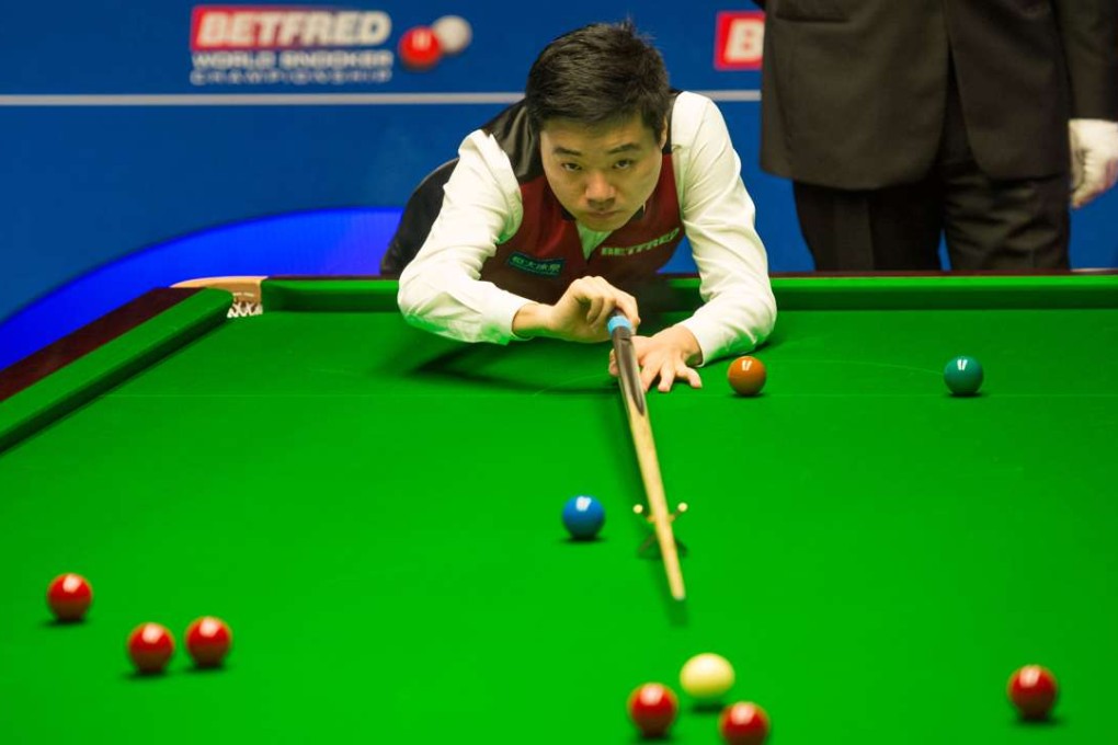 Ding Junhui of China competes during the second-round match against Judd Trump of England at the Crucible Theatre in Sheffield, England. Ding won 13-10. Photo: Xinhua