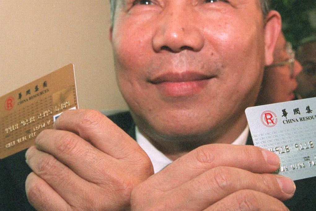 A man holds new visa credit cards. China’s central bank is relaxing restrictions on the credit-card market in January.