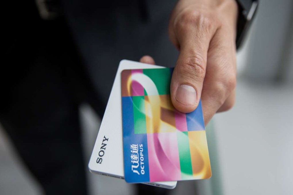 A man holds an Octopus card on top of a card reader for the O! ePay mobile payment service. Photo: Bloomberg