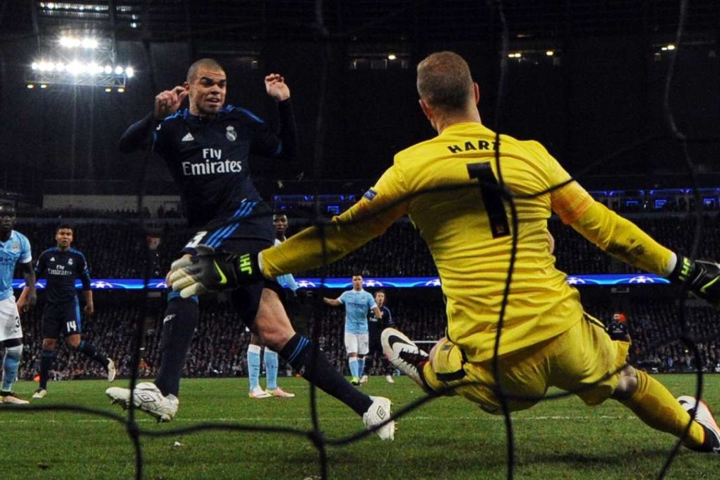Manchester City goalkeeper Joe Hart saves a close-range shot from Real Madrid defender Pepe. Photo: AFP